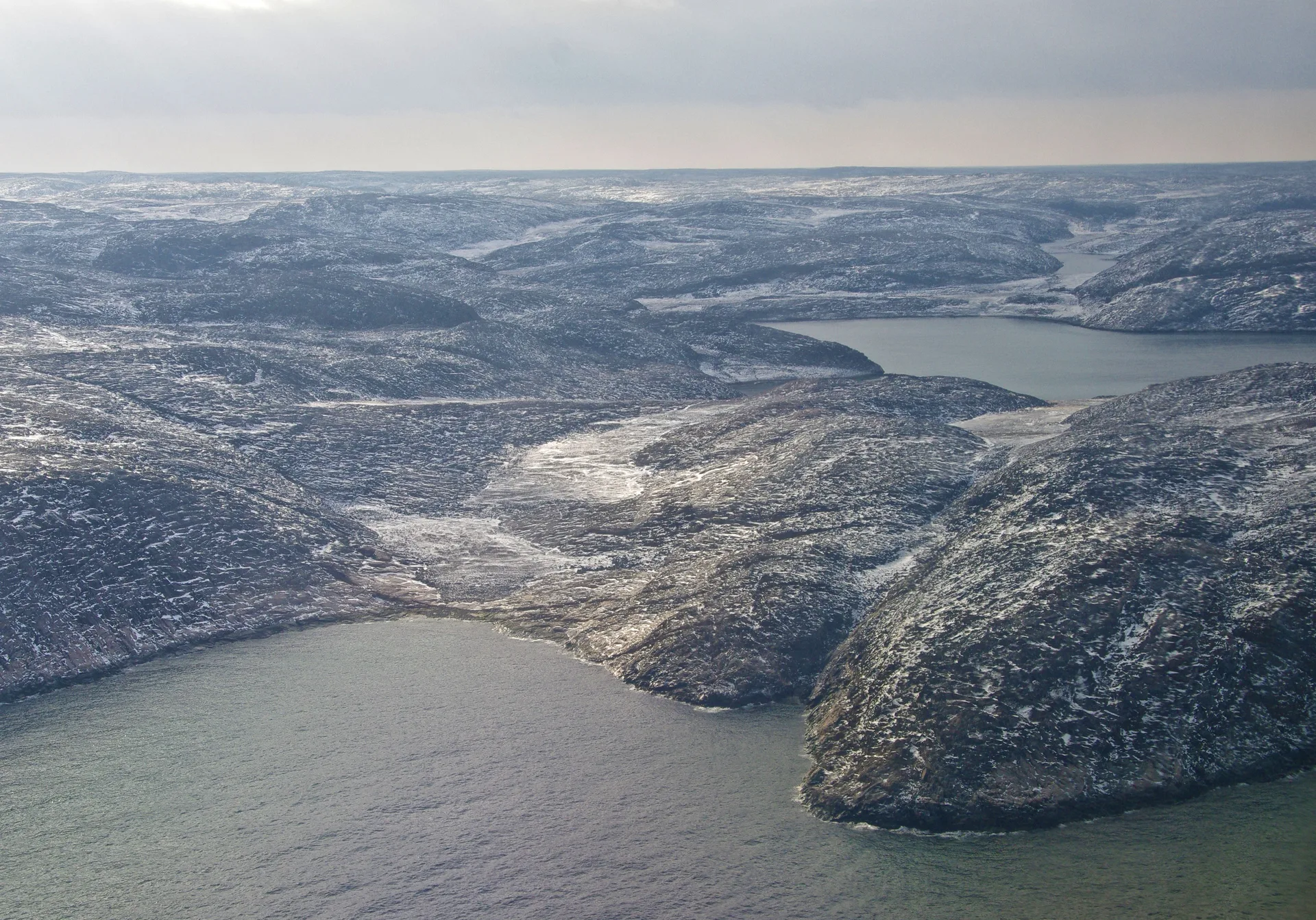 Waterways winding through the rocky, snow-dusted Nunavik tundra